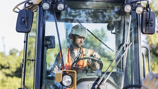 A closeup of a hand installing car window tinting.
