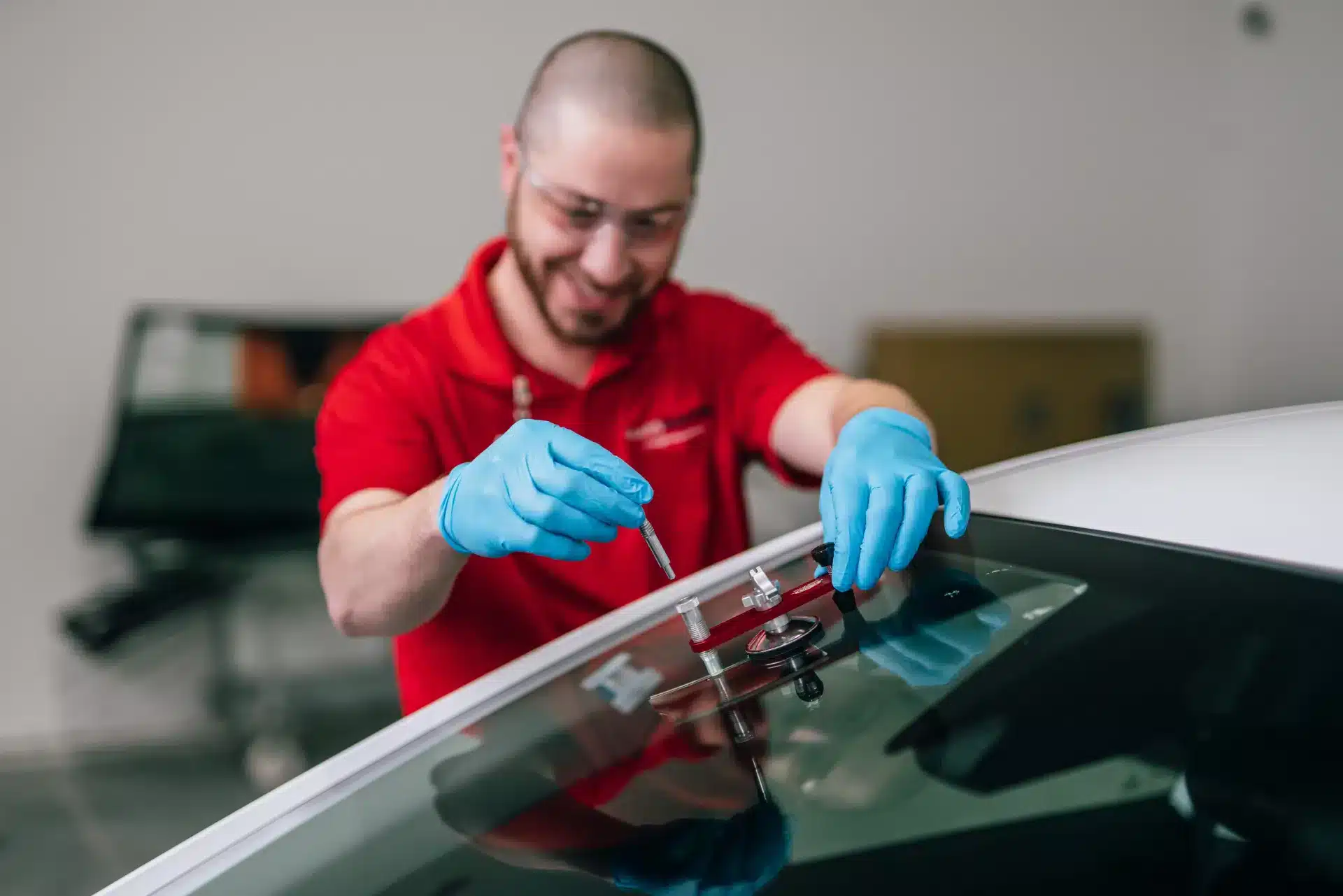 A Glass Doctor technician repairing a windshield chip during auto glass repair service.