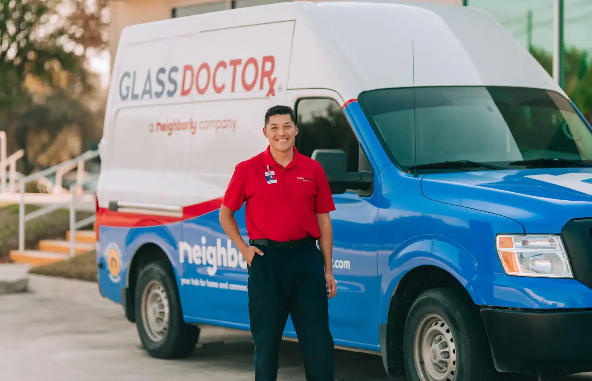 Glass Doctor glass specialist standing by a branded service van, ready to provide windshield replacement services.
