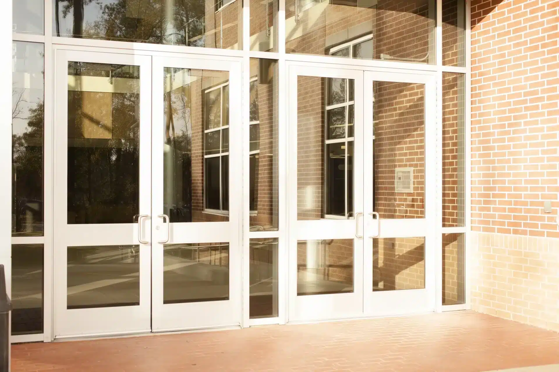 Commercial glass door repair for a building's aluminum-framed glass entry doors.