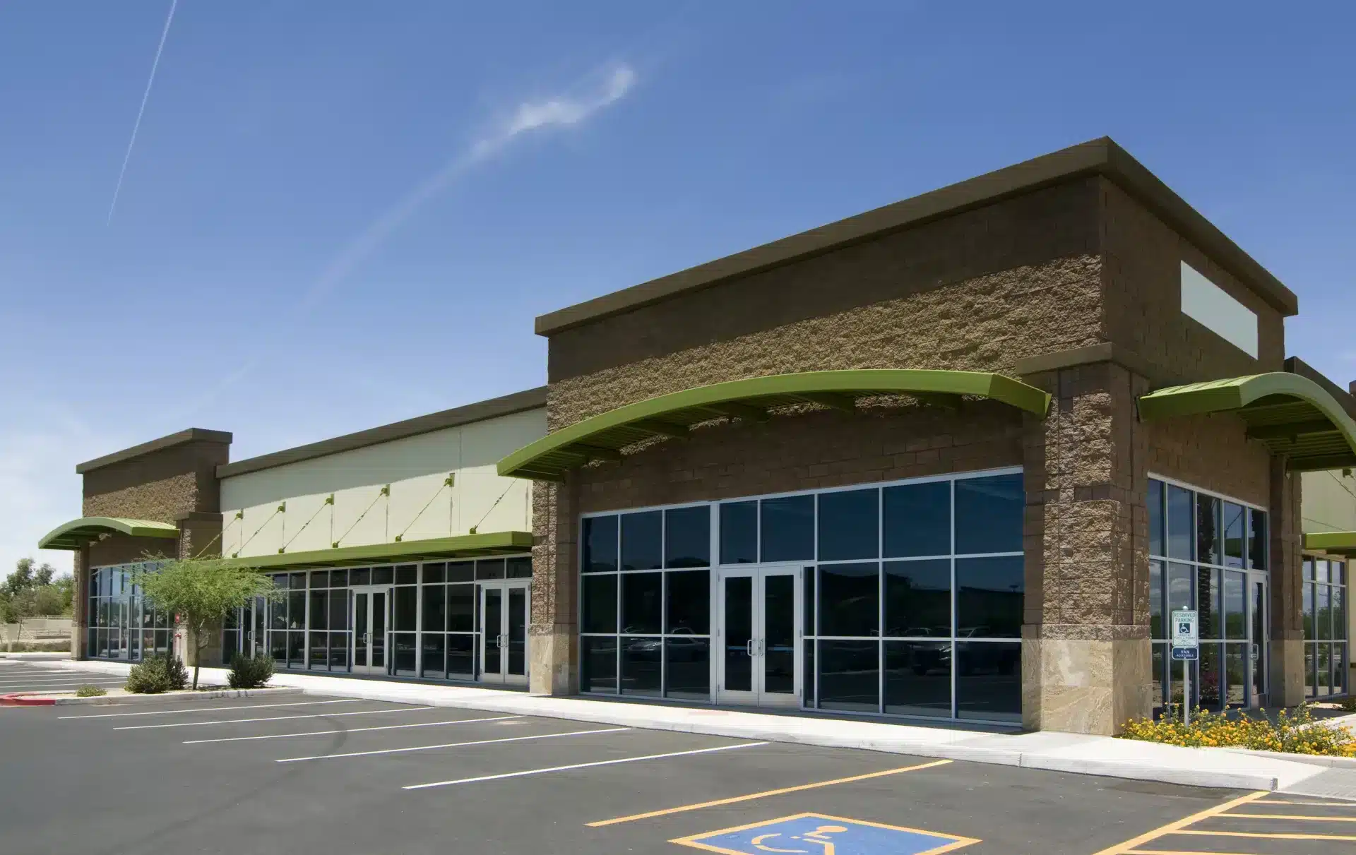 Commercial glass repair and replacement for retail storefronts with large glass windows and glass entry doors.