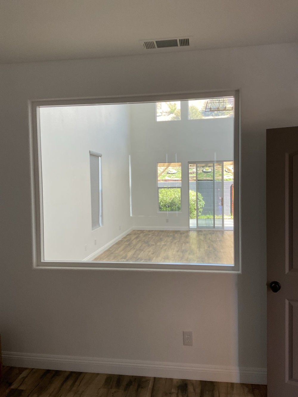 Interior window installation in a Murrieta, CA home, showing a large clear glass panel framed within an interior wall to provide light and visibility between rooms.