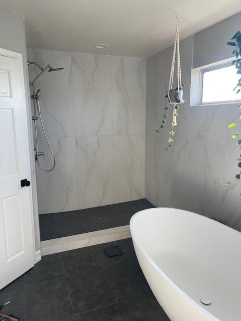 Installing a heavy frameles glass shower unit.