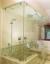 frameless all-glass shower enclosure with ceiling mounting and swinging door