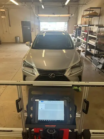 ADAS calibration service being performed on a silver SUV after a windshield replacement by Glass Doctor Auto of Castle Rock.