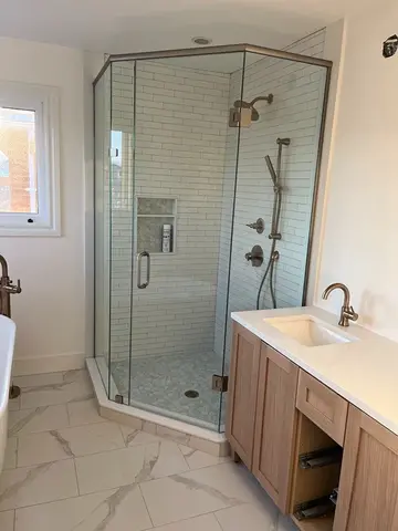 A shower with an angled frameless glass door panel and a top frame from Glass Doctor of Barrie, ON.