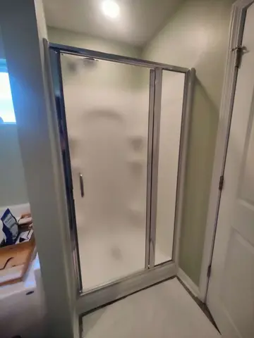 A frosted glass shower and chrome framing by Glass Doctor Home + Business of Myrtle Beach.