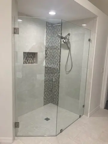 A frameless glass shower door installed on a tile standing shower by Glass Doctor of Tampa Bay.