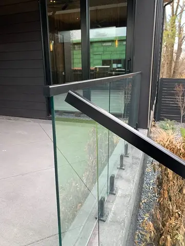 A close-up on part of a custom glass and metal porch railing by Glass Doctor of Nashville.