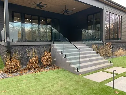 Decorative glass panels installed by Glass Doctor of Nashville create a custom railing around a porch and down a set of steps.