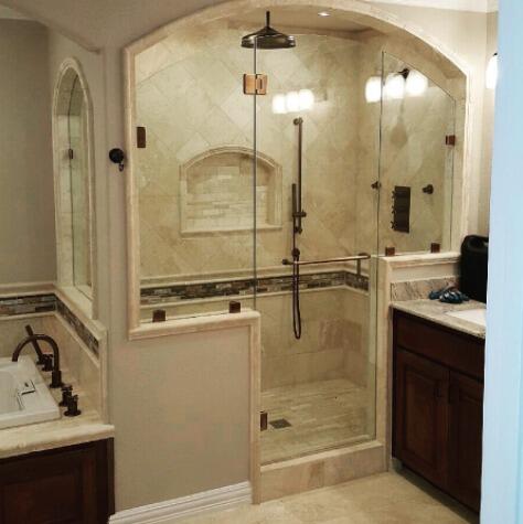 Frameless glass panels with a customed curved top enclosing a walk-in shower by Glass Doctor of Ocala.