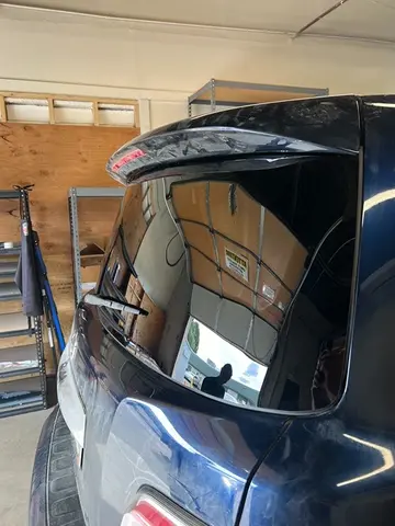 A blue SUV with a newly installed back glass replacement by Glass Doctor Auto of Castle Rock.