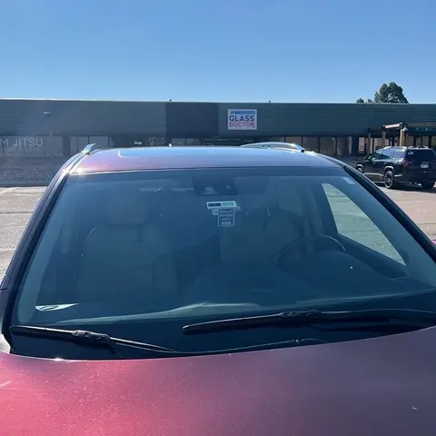 A new windshield installed on a red vehicle by Glass Doctor Auto of Castle Rock.