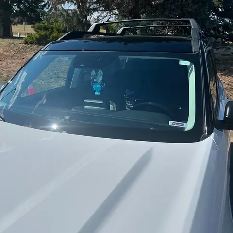 A new windshield on a white SUV installed by Glass Doctor Auto of Castle Rock.