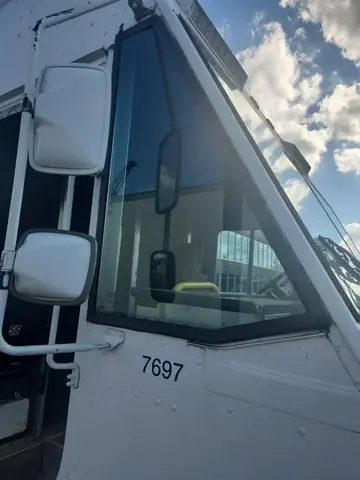The side window of a white delivery truck after having the glass replaced by Glass Doctor Auto of Southampton.