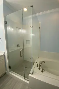 90-degree frameless glass on a walk-in shower with a swing door and brushed nickel hardware by Glass Doctor of Raleigh