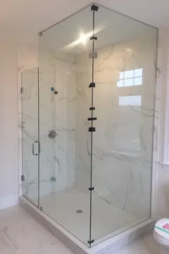 Frameless glass panels being installed on a corner shower with a 90-degree angle by Glass Doctor of York Region.