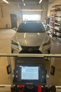 ADAS calibration service being performed on a silver SUV after a windshield replacement by Glass Doctor Auto of Castle Rock.