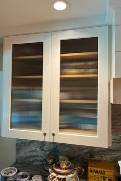 Textured glass inserts in the doors of a storage cabinet by Glass Doctor of Tampa Bay.