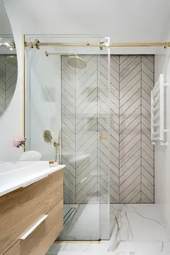 A contemporary shower with sliding glass doors.