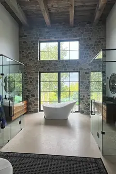 A custom bathroom with two glass enclosures with top frames installed by Glass Doctor of Newmarket.