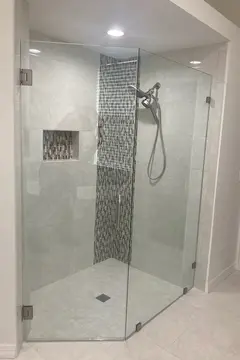 A frameless glass shower door installed on a tile standing shower by Glass Doctor of Tampa Bay.