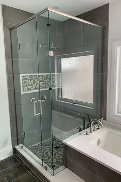A gray tile shower with a 90-degree custom glass enclosure by Glass Doctor of Barrie, ON.