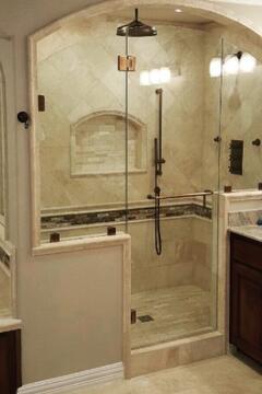Frameless glass panels with a customed curved top enclosing a walk-in shower by Glass Doctor of Ocala.