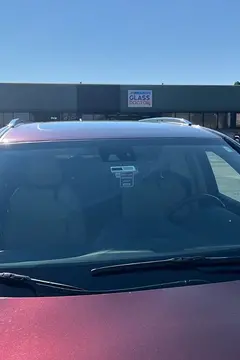 A new windshield installed on a red vehicle by Glass Doctor Auto of Castle Rock.