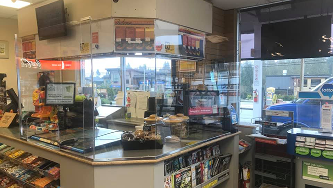 Gas station counter with glass barrier.