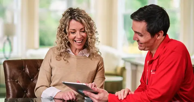 A glass doctor technician with a women customer.