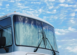 Close-up of a bus windshield with wipers.