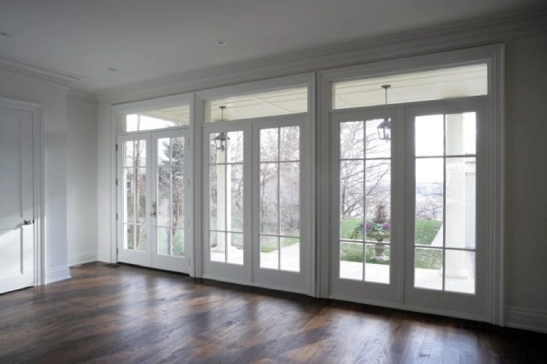 Bright interior featuring large French doors with glass panes.