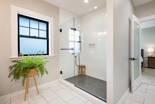 Bathroom interior with glass shower enclosure.