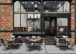 Rustic outdoor seating in front of brick and glass storefront.