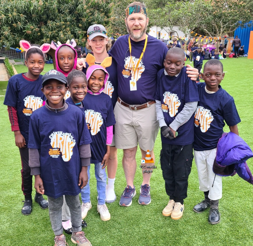 Larry Patterson with the children he sponsors through Arise Africa
