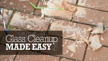 A broken glass dish on a brick pavement