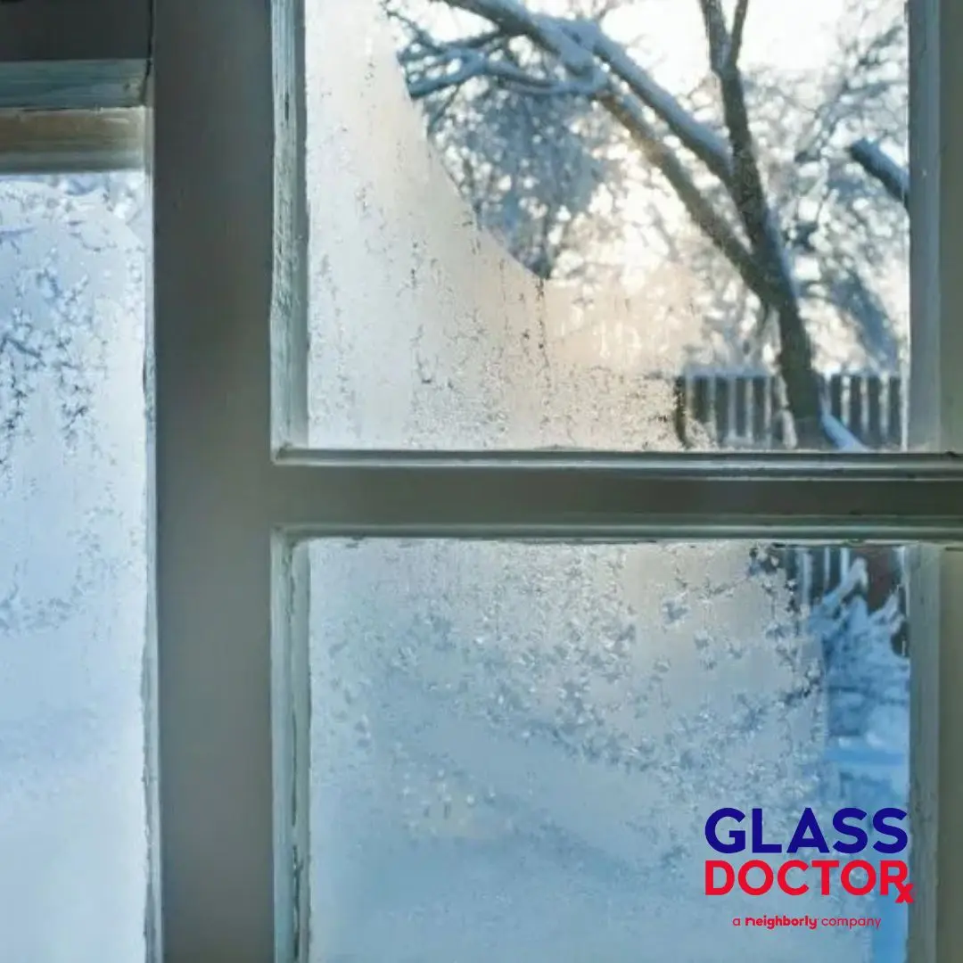 Ice and frost forming on residential window glass during winter in Meridian ID due to poor insulation and air leaks