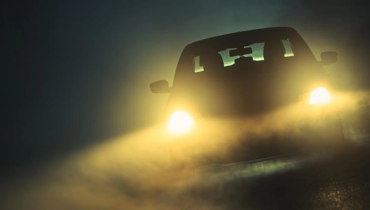 Car driving in fog