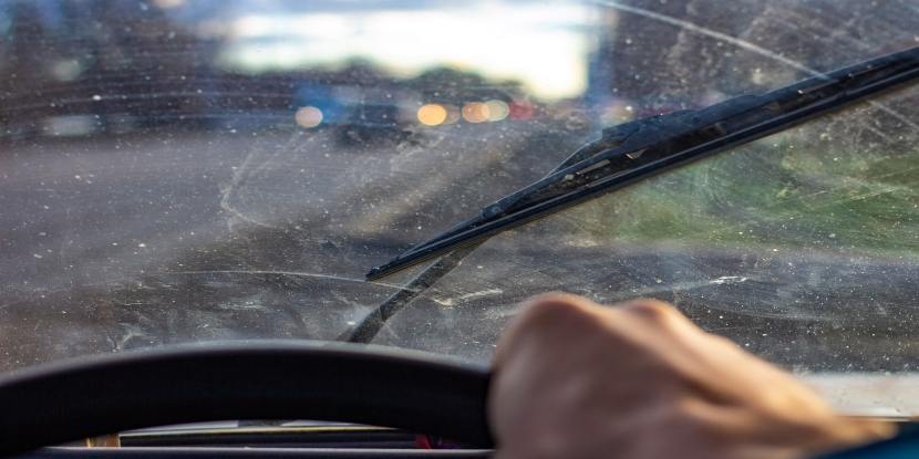 Dirty scratched car windshield view from inside car