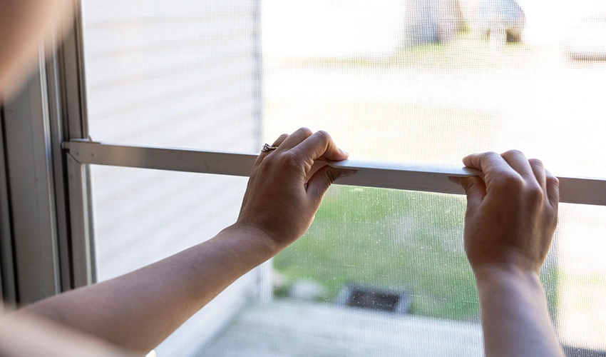 Self-storing storm window