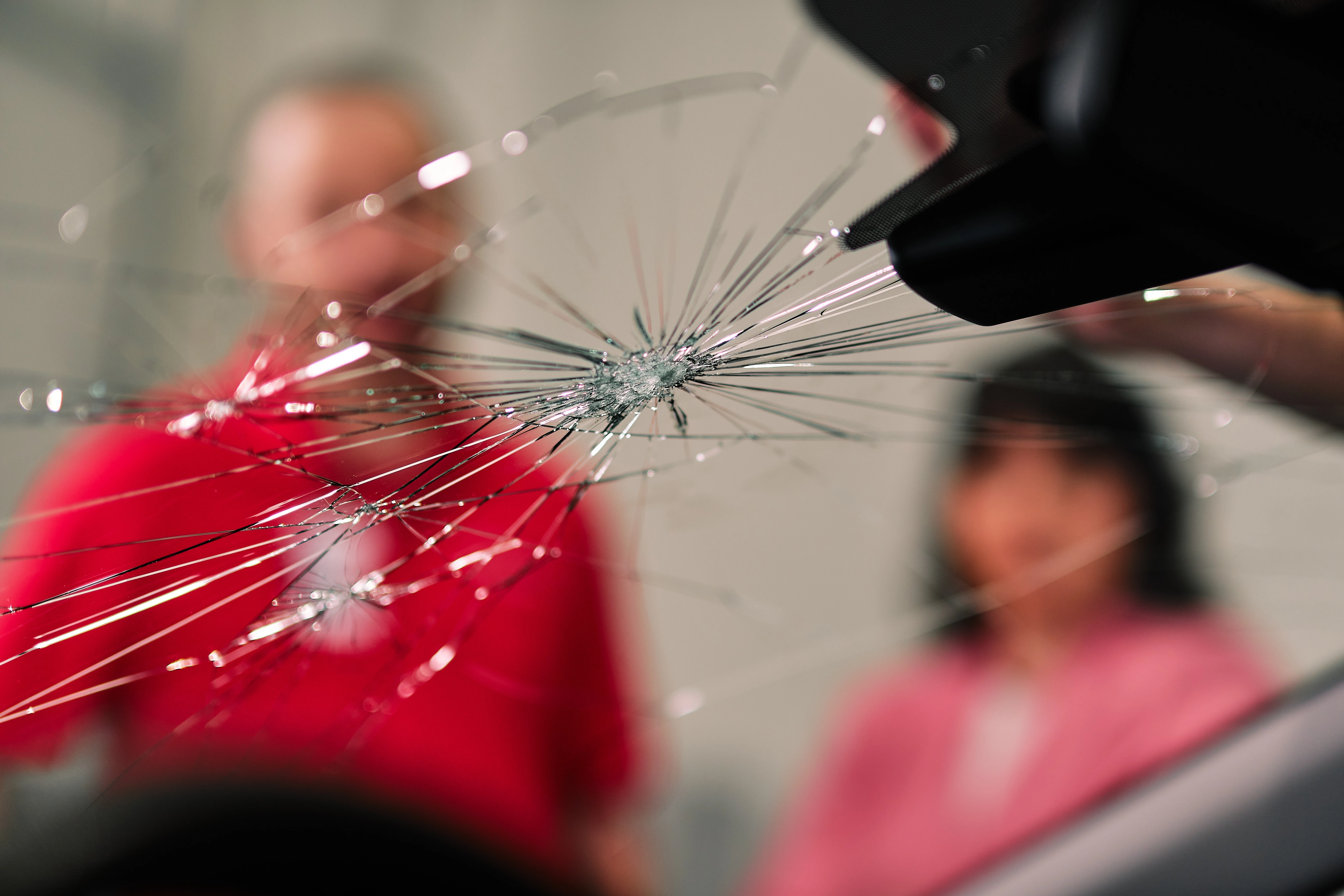 Glass Doctor professional and customer staring at cracked windshield