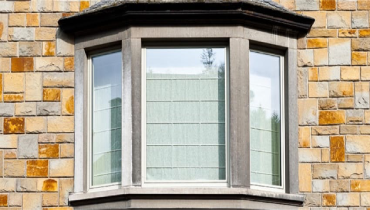 A bay window on a brick house